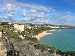 a view of a beach and the ocean at B&B L'EDEN DI CAPO BIANCO in Montallegro
