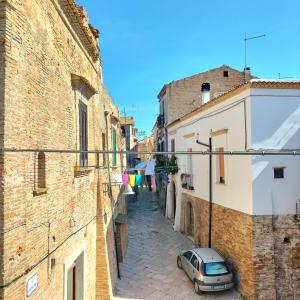 a car parked in an alley between two buildings at Casa FLAVIA in Serracapriola +9 photos