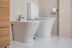 a bathroom with a toilet and a sink at 1 bedroom for 4 people with pool Puerto de la Cruz in Puerto de la Cruz +8 photos