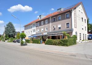 a large building on the side of a street at Hotel Häußler in Langenbruck