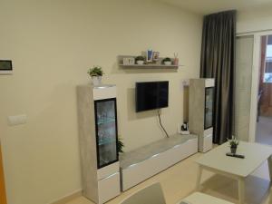 a living room with a flat screen tv on a wall at Vera Playa apartment in Vera