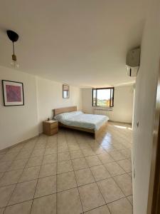 a bedroom with a bed and a tiled floor at Dimora dei Colli in Pignataro Maggiore +16 photos