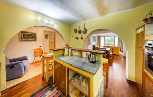 a kitchen and living room with an archway at Villa Lucciola in Stresa