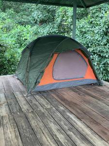 a tent sitting on top of a wooden deck at Corcovado Camping in Puerto Jiménez