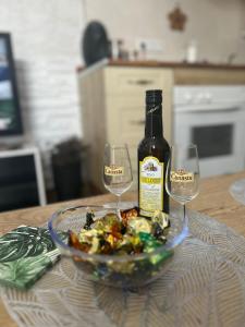 a bottle of wine and two wine glasses on a table at Geminis in Rota