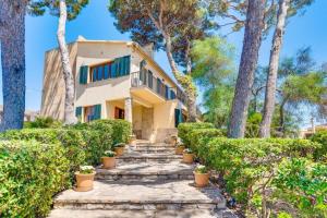 a house with trees and stairs in front of it at Nice house by the sea very near of Palma by Renthousing in Can Pastilla
