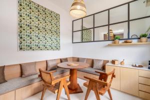 a dining room with a bench and a table and chairs at The Peak - 2BR Luxury Hill Villa Nusa Dua in Nusa Dua