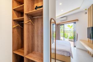 a room with a wooden closet with a bed in it at The Peak - 2BR Luxury Hill Villa Nusa Dua in Nusa Dua +53 photos