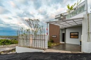 a building with a balcony with a fence at The Peak - 2BR Luxury Hill Villa Nusa Dua in Nusa Dua