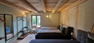 a bedroom with two beds and a window at Visionary Hospitality Bassersdorf, Zürich - Premium Apartments in Swiss Style with Free Parking, Washer, Kitchen, Terrace, Vaulted Cellar Event Room, Bus Stop, 15' City & Airport in Bassersdorf