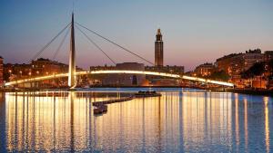 a bridge over a body of water at night at Studio "En Coeur de Ville" - Proche Mairie et Quartier Perret - Calme et Charmant in Le Havre