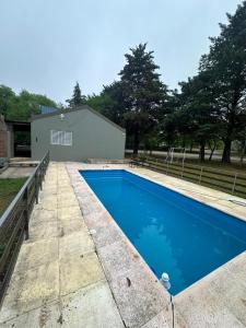a swimming pool in front of a house at Casa Madison in Casa Grande