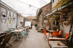 a street with tables and chairs in an alley at Treck Hostel in Ghent