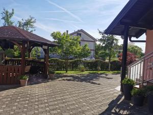 a patio with a gazebo and a house at Apartmani Jastreb 2 in Jastrebarsko
