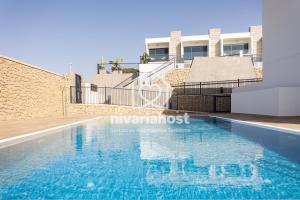 a swimming pool in front of a building at The Oasis El Medano, by Nivariahost in El Médano