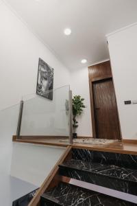 a staircase in a house with a glass wall at The Palm Terrace Penthouse 3BR - Palm Hills - 280 sqm in Cairo +136 photos
