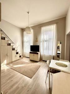 a large living room with a television and a table at Ava Central Residence in Budapest