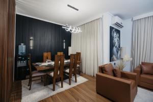 a dining room and living room with a table and chairs at The Palm Terrace Penthouse 3BR - Palm Hills - 280 sqm in Cairo