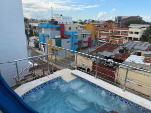 a hot tub on the balcony of a building at Hotel Maria Bonita Higüey in Higuey