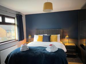 a bedroom with a bed with two towels on it at Home from Home in Six Road Ends