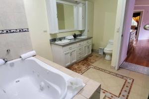 a bathroom with a tub and a sink and a toilet at Casa de lujo moderna y amplia in Cuenca +23 photos