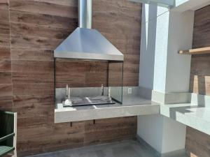 a kitchen with a hood over a counter at Metrô Studio Alto do Ipiranga in São Paulo +49 photos