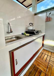 a kitchen with a sink and a counter top at Vallari Besakih Homestay in Besakih +3 photos