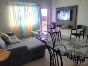 a living room with a couch and a glass table at Tropical Bliss Haven in Kingston