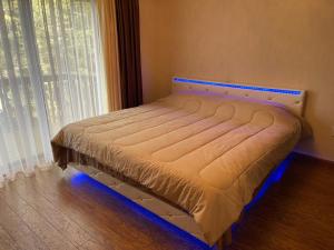 a bed in a room with a large window at Luxury Pocono Retreat with hot tub, sauna, fire pit, and patio in East Stroudsburg