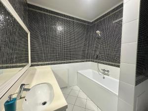 a bathroom with a sink and a tub and a toilet at Апартаменты 2 комнатная возле теннисного центра in Aktobe +12 photos