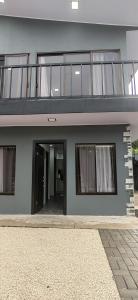 a large house with a balcony and a door at DEPARTAMENTOs HABY 1 in Paquera