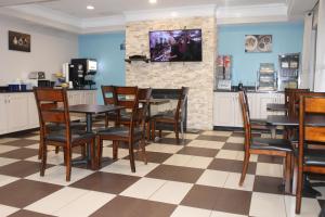 a dining room with tables and chairs and a fireplace at Days Inn by Wyndham Budd Lake in Budd Lake