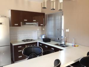 a kitchen with a sink and some chairs in it at Dreamhome in Balaclava