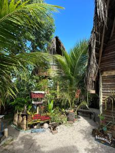 a resort yard with a sign and palm trees at Flor da Aldeia Eco Hospedaria in Camaçari