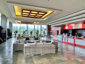 a lobby with couches and tables in a restaurant at Waikiki 30FL Luxury Studio with Majestic Ocean Fireworks in Honolulu