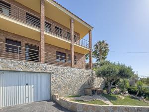 a house with a garage and a building at Villa Mar & Natura Sitges in Canyelles