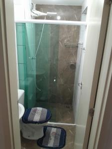 a bathroom with a toilet and a glass shower at Lar feliz in Juiz de Fora +7 photos