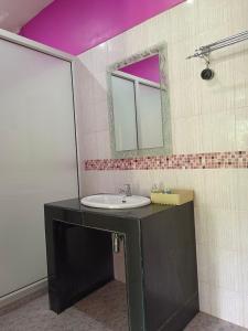 a bathroom with a sink and a mirror at Khao Sok Country Resort in Khao Sok +90 photos