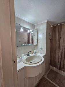 a bathroom with a sink and a mirror at MilosBluePearl in Triovasálos +14 photos
