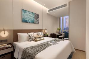 Katil atau katil-katil dalam bilik di Somerset QPlex Shenzhen