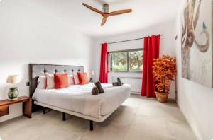 a bedroom with a large bed with red curtains at Villa La Roca con casita independiente in Guadarrama +43 photos