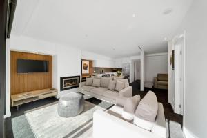 a living room with a couch and a fireplace at Residence du Parc - Luxury Apartment in Queenstown