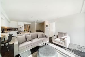 a living room with a couch and two chairs at Residence du Parc - Luxury Apartment in Queenstown