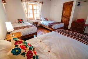 Postel nebo postele na pokoji v ubytování Picaflor Tambo Guest House