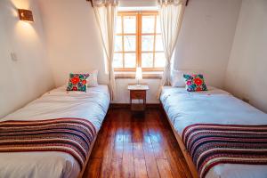 Postel nebo postele na pokoji v ubytování Picaflor Tambo Guest House