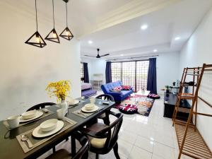 a dining room and living room with a table and chairs at Affordable 12 Guest Kota Damansara Thomson Hospital Dataran Sunway Giza OneUtama Ikea The Curve in Petaling Jaya