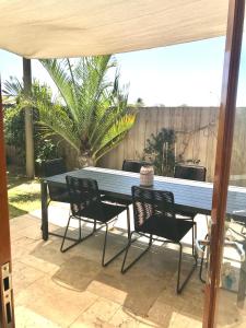 a blue table and chairs on a patio at Salty Blue Beach House in Kalbarri