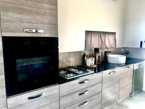 a kitchen with a stove and a counter top at Salty Blue Beach House in Kalbarri