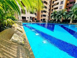 a swimming pool with blue water in a building at Affordable 12 Guest Kota Damansara Thomson Hospital Dataran Sunway Giza OneUtama Ikea The Curve in Petaling Jaya