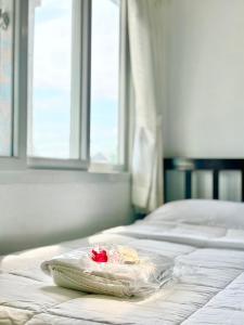 a plastic bag on a bed in a room at LSN Mansion in Bangkok